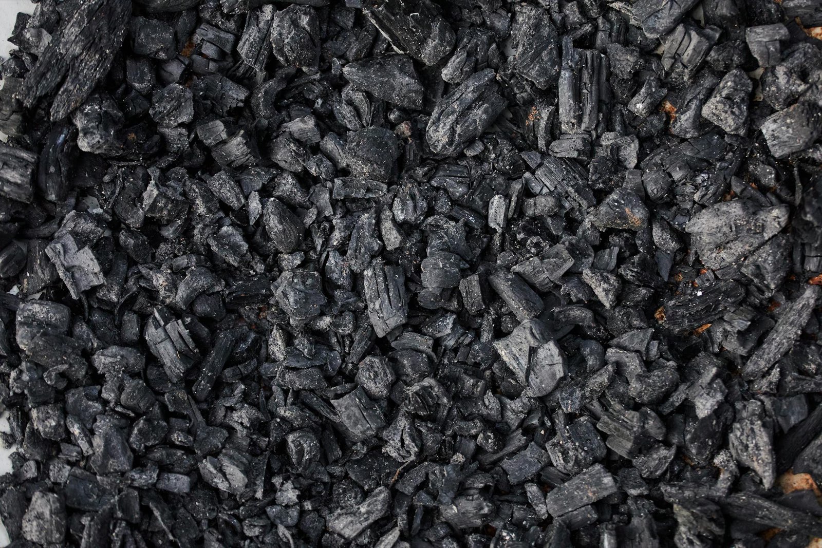 Close-up of black, porous biochar granules